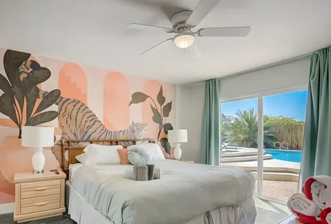 Bedroom with feature mural wall and backyard access at a rental property we manage in Las Vegas, Nevada
