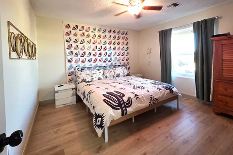 Guest bedroom with patterned feature wall at a rental property we manage in Chandler, Arizona
