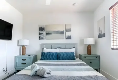 Primary bedroom with queen bed and matching nightstands at a rental property we manage in Las Vegas, Nevada