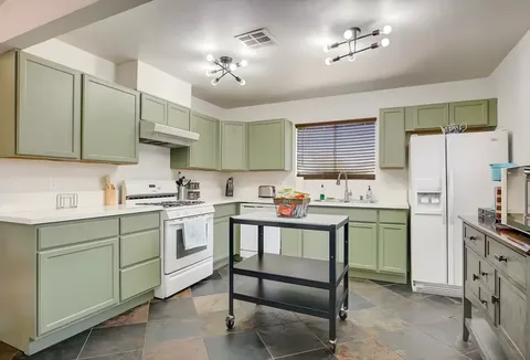 Kitchen with full appliances and prep island at a rental property we manage in Las Vegas, Nevada