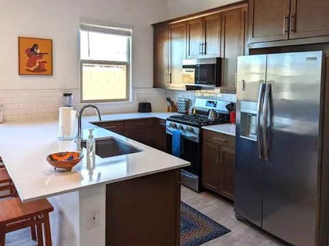 Kitchen with breakfast bar island and stainless appliances at a rental property we manage in Phoenix, Arizona