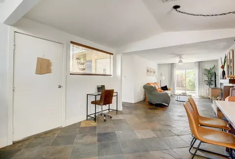Vaulted living and dining space with slate flooring at a rental property we manage in Las Vegas, Nevada