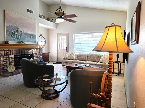 Living room with brick fireplace and vaulted ceiling at a rental property we manage in Chandler, Arizona