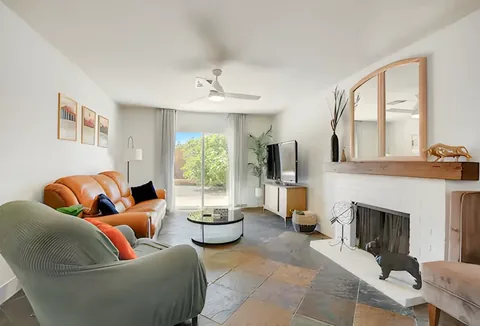 Open living room with fireplace and slate tile flooring at a rental property we manage in Las Vegas, Nevada