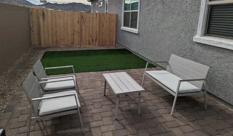 Private patio with artificial turf and outdoor seating at a rental property we manage in Phoenix, Arizona